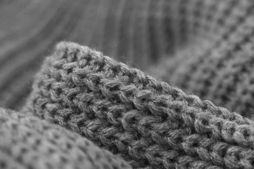 Macro detail of a chunky grey wool knit